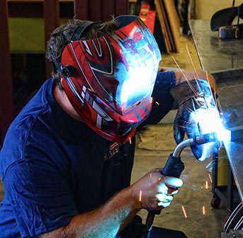 A welder working on a custom welding project